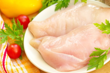 Raw chicken fillet with spices and vegetables