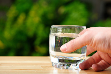 holding glass of water