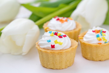 Obraz na płótnie Canvas Delicious cupcakes with spring tulips
