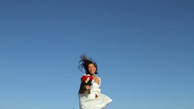 Bride jumping for joy