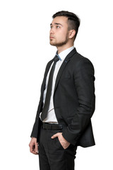 Young man a business suit, hands in his pockets, isolated on white background