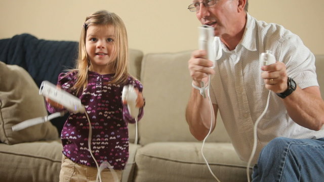 Grandfather playing games with gradndaughter