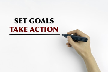 Hand with marker writing: Set Goals, Take Action