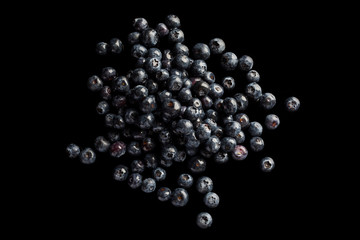 Heap of blueberries on black background directly from above