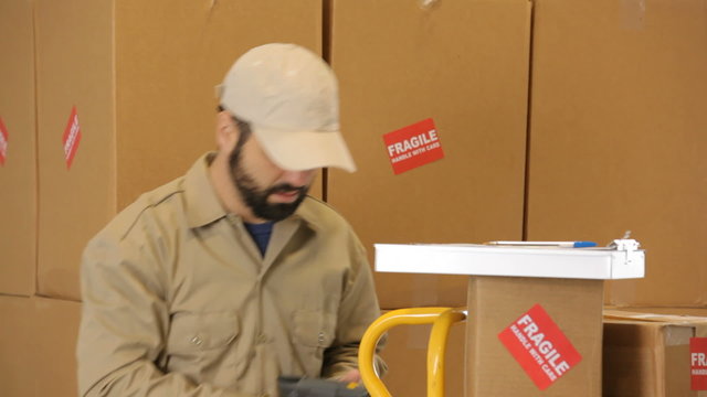 Delivery man working in shipping warehouse