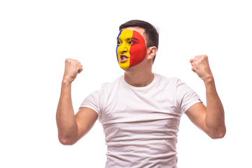 Naklejka premium unexpectedly happy and success emotions of Romanian football fan in game support of Romania national team on white background. European football fans concept.
