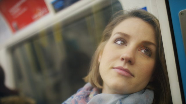 Young woman alone in her thoughts on a train