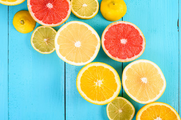 Lemon, Orange, Grapefruit And Lime Citrus Fruit Slices On Turquoise Table