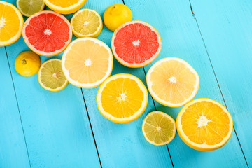 Lemon, Orange, Grapefruit And Lime Citrus Fruit Slices On Turquoise Table