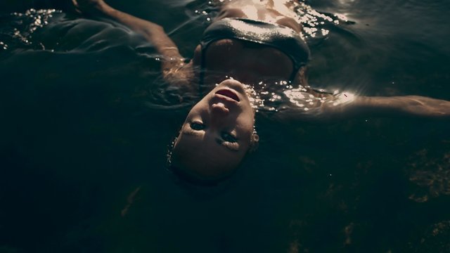 Sexy Young Woman in Bikini Floating