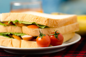 Breakfast,meal,sandwich with sausage,lettuce and tomatoes