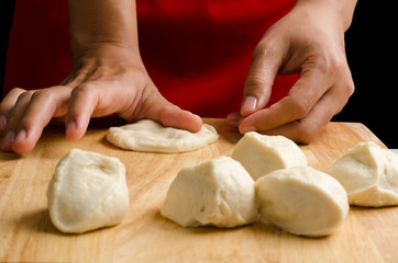 Cutting and kneading dough on wooden plate,bun cooking