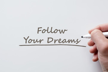 Follow your dreams written on whiteboard