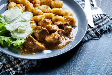 Italian potato dumplings with stew and cucumber salad