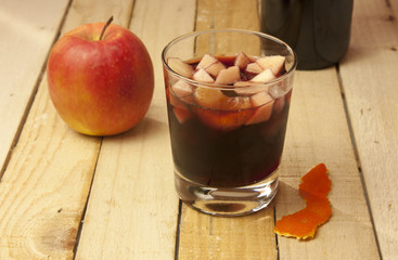 Sangria with apple, on rustic wooden texture, with copyspace
