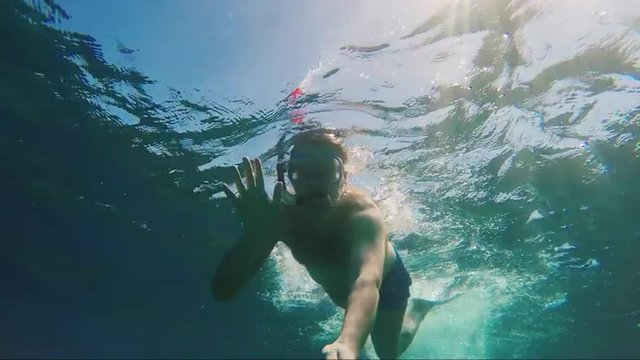 Snorkelers pictures of themselves with selfie sticks