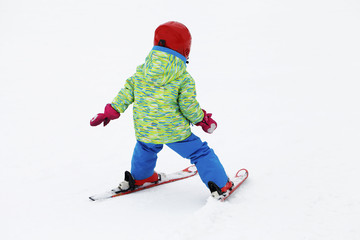 Fototapeta na wymiar small active child skiing on snow slope