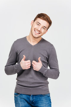 Cheerful Attractive Young Man Showing Thumbs Up With Both Hands