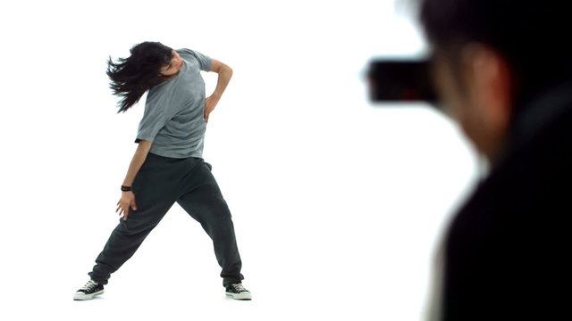 Photographer shoots hip hop dancer in studio, slow motion