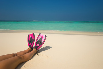 Fototapeta na wymiar Woman relaxing on summer beach vacation holidays lying in sand.
