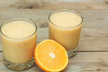 couple of glasses of fruit smoothies and sliced orange