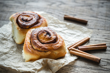 Cinnamon roll on the wooden background