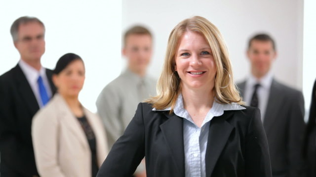 Portrait of business woman with co-workers in background