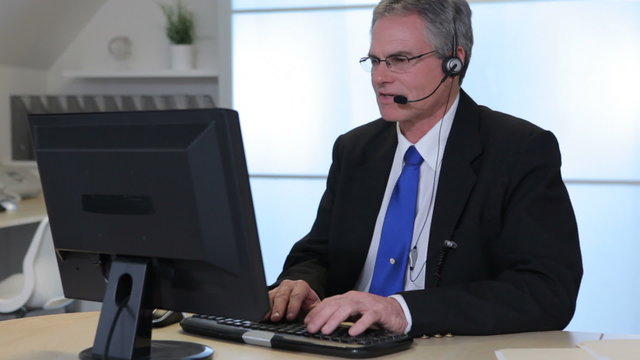 Portrait of business man in office with headset