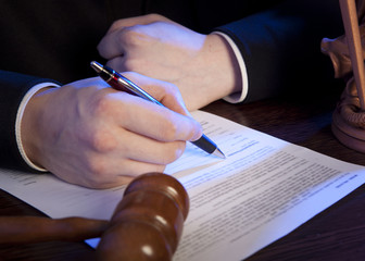 Male judge in a courtroom striking the gavel