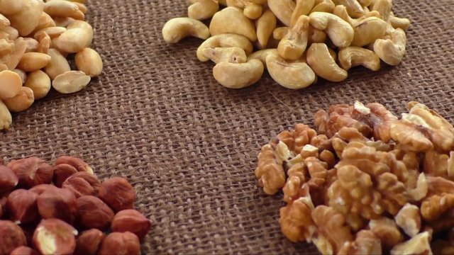 Almonds, cashew, walnuts and hazelnuts lying on burlap 
