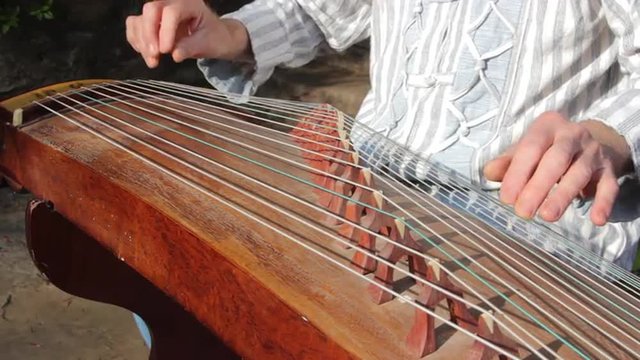 Man is playing the Guzheng-chineese harp