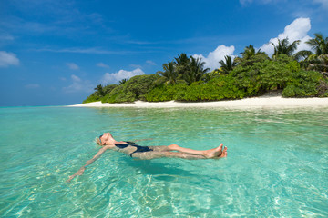 Cute woman relaxing on the tropical beach