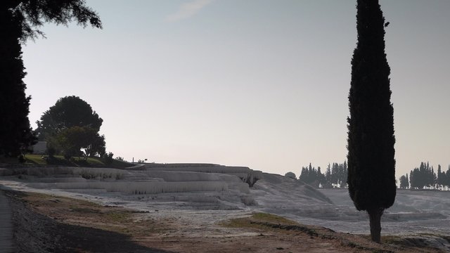 White travertines with silhouttes of trees, Pamukkale, Turkey. 4k