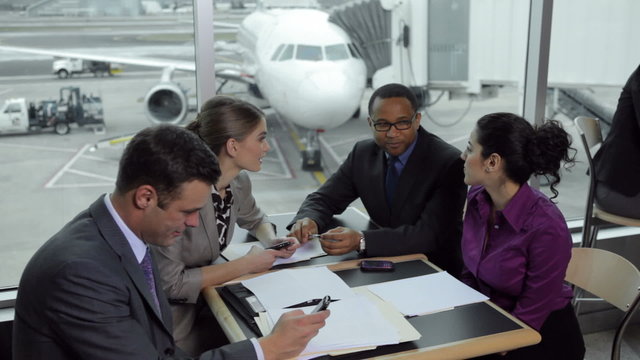 Business people having meeting at airport