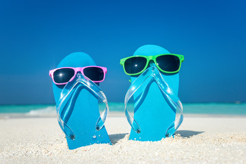 flip-flops and sunglasses by the sea