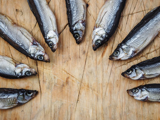 Dried fish on a cutting board. Space for text.