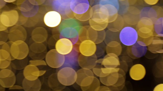 Panning shot of colorful circle bokeh lights, out of focus
