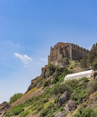 Ancient Stavrovouni Monastery (327-329 AD) on mountain against blue sky background. Cyprus.
