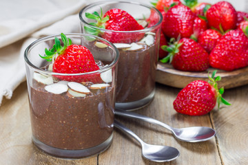 Chocolate chia seed pudding garnished with almond slices and strawberry