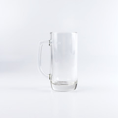 Empty beer mug against white background