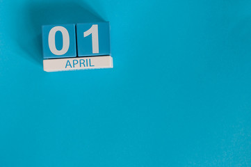 April 1st. Image of april 1 wooden color calendar on blue background.  Spring day, empty space for...