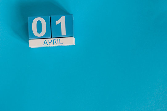 April 1st. Image of april 1 wooden color calendar on blue background.  Spring day, empty space for text. All Fool's Day