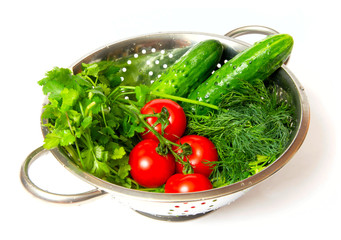 cucumbers. red tomatoes and green arugula in a metal pan
