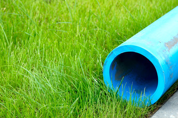 Harmless polyethylene water pipes on a green grass