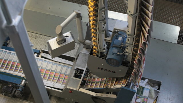 conveyor belt transporting printed newspaper in Industrial printing press