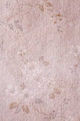 Old textured paper background with vintage flower ornament