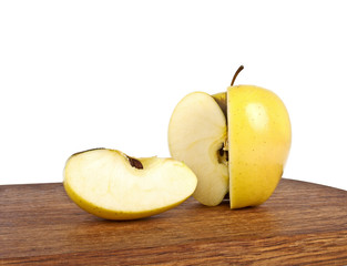 Naklejka na ściany i meble Yellow apple and slice on wooden cutting board on a white backgr