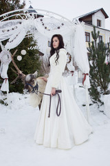 Fototapeta premium Beautiful bride in a fur cape with reindeer