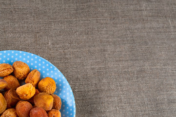 Top view of dried apricots heap on plate 