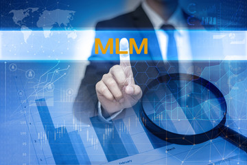 Businessman hand touching MLM button on virtual screen